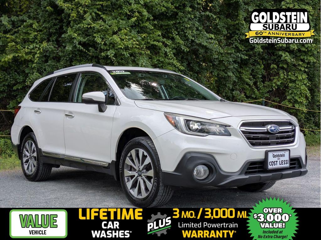 2019 Subaru Outback Touring in Crystal White Pearl — front three-quarter view